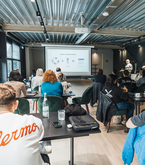 Une salle d'atelier pleine de participants face à une présentation